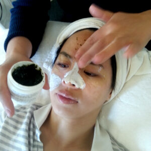 Woman getting a mask applied to face during a facial.